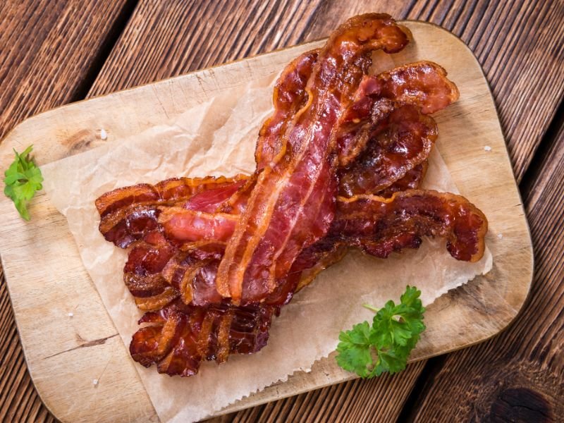 several crispy strips of bacon on parchment paper