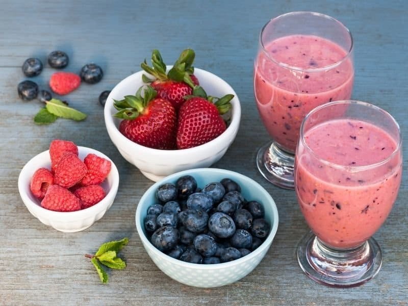 bowls of blueberries, strawberries and raspberries for delicious fruit smoothies