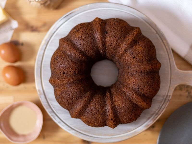 beautiful chocolate Bundt cake on a white rustic platter