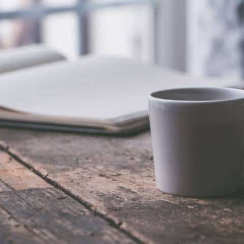 a cup of Chai Latte Mix in a white mug on a wooden table on a cold day