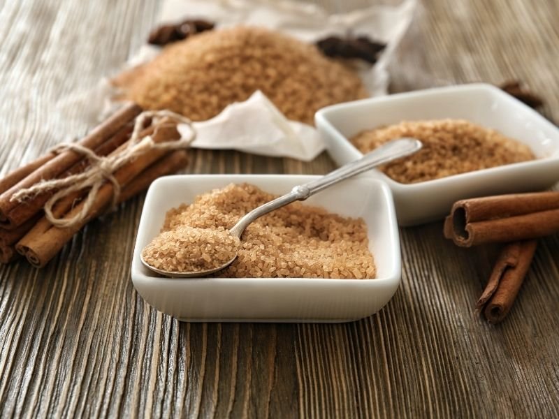 cinnamon sugar and cinnamon sticks on a wooden table