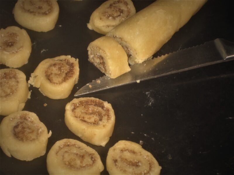 slicing cinnamon pinwheel cookies 