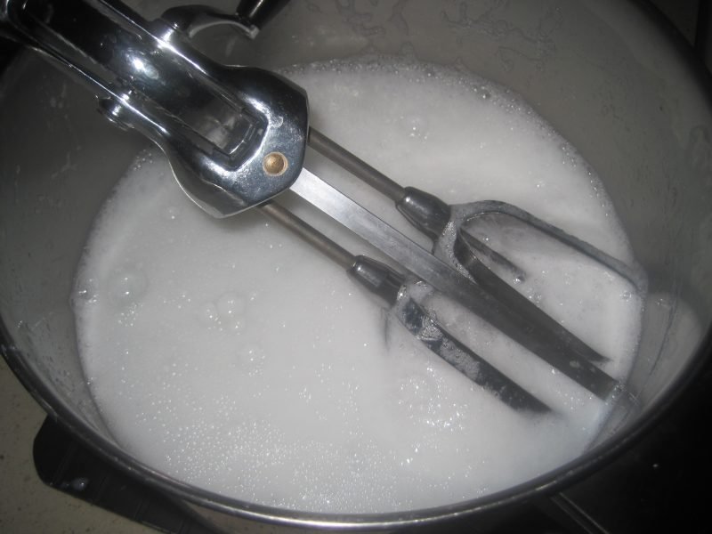 DIY Liquid Handsoap in a kettle with a hand beater to mix it