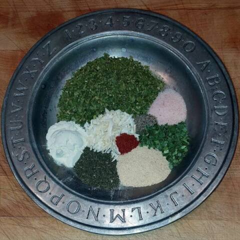 herbs and spices on a plate for making ranch seasoning mix