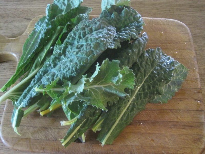 Kale and Chard on a wooden cutting board