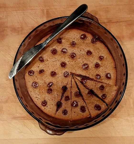 Light Blonde brownies in a pie plate on a wooden cutting board