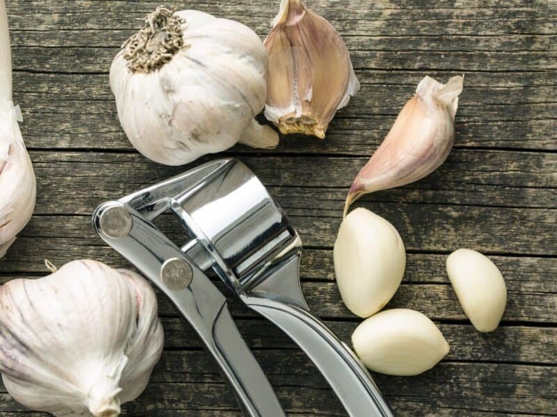 garlic with a garlic press on a table