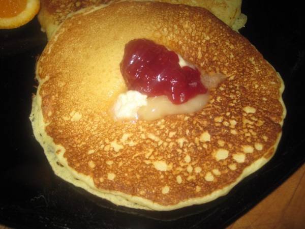 pancake fresh off the griddle with butter and raspberry jam