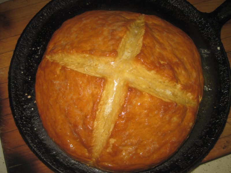 cross on top of beautiful loaf of golden brown bread