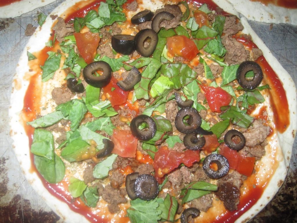 Tortillas Pizza with Kale ready for the cheese to be added