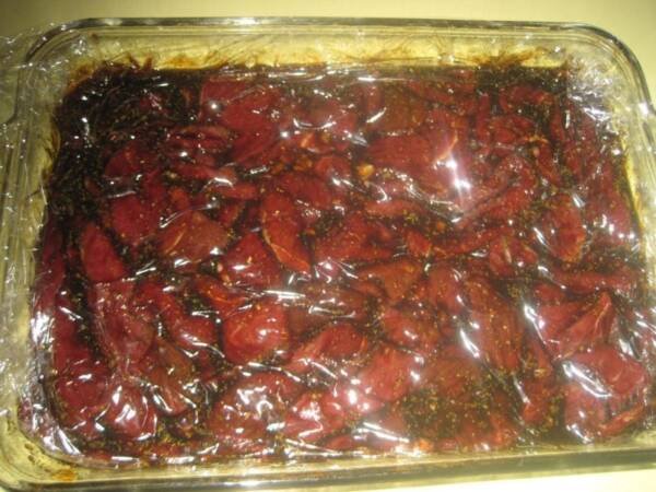 Jerky meat marinading in brine.