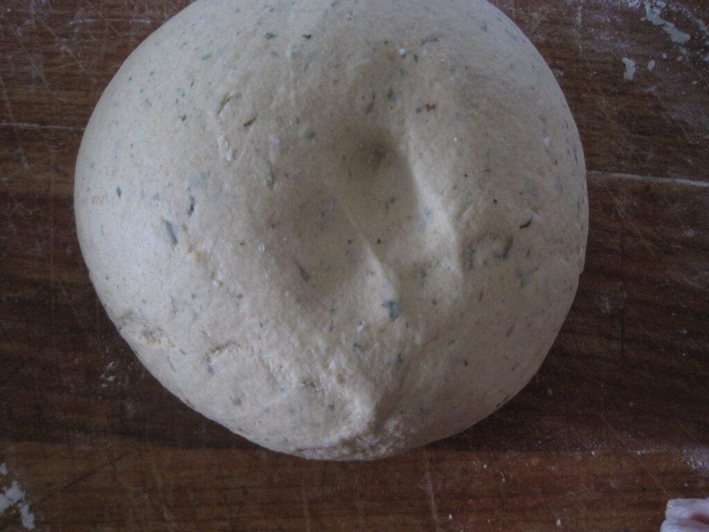 finger indentions in freshly raised bread dough
