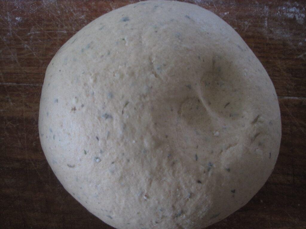 finger indentions showing in a ball of bread dough