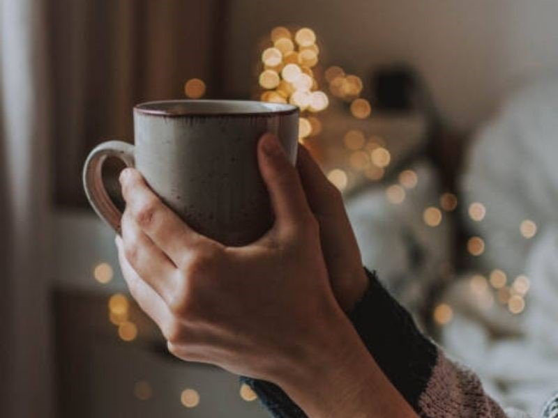 woman holding a mug of Homemade Drinking Chocolate during the holidays
