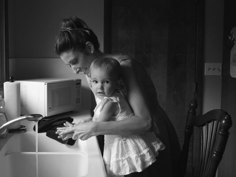 Mother and Daughter Washing Hands in the kitchen sink