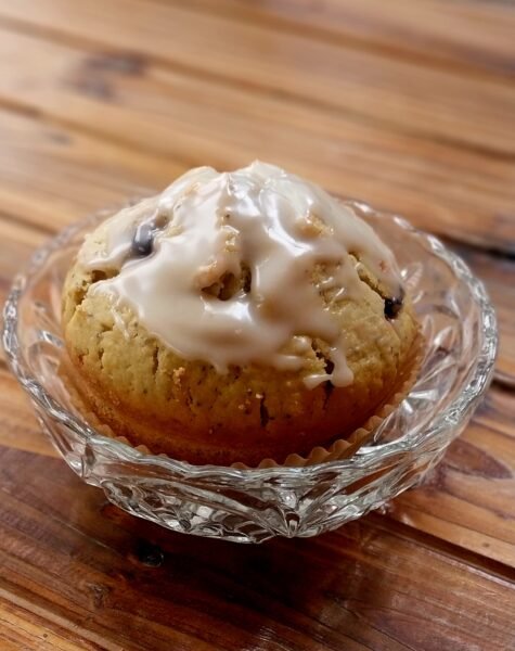 fresh homemade blueberry, lemon and poppy seed muffin in a small glass dish