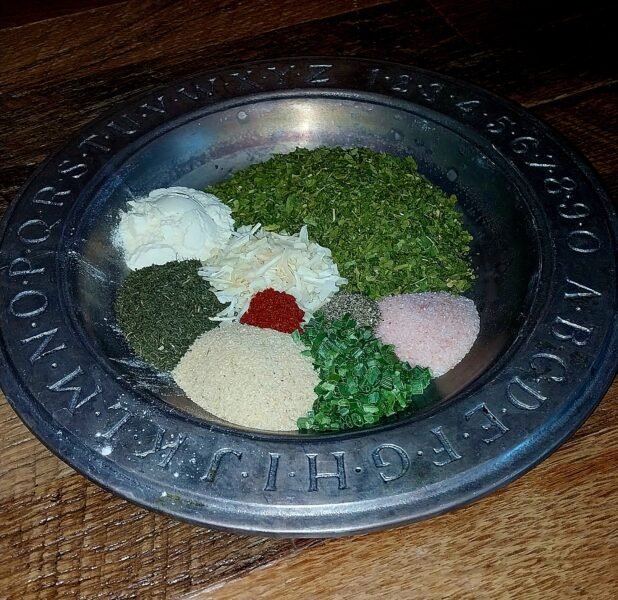 pewter plate with little piles of herbs and spices for making ranch dressing mix