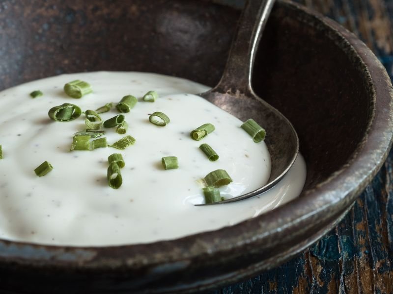 a brown ceramic bowl of freshly made ranch dressing mix