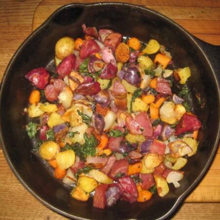 Roasted Potatoes and Vegetables in a black cast iron skillet