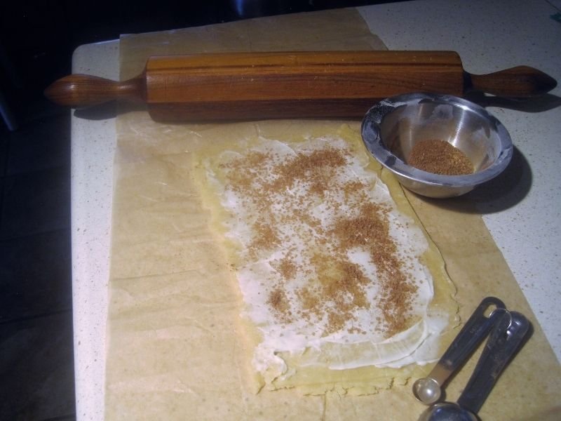 pastry crust being rolled out for cinnamon pinwheel cookies