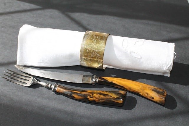 Rustic Table setting with wood handled fork and knire and white linen napkin