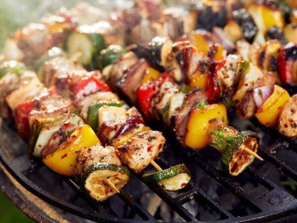 colorful veggie and chicken Shish Kabobs cooking on an outdoor grill