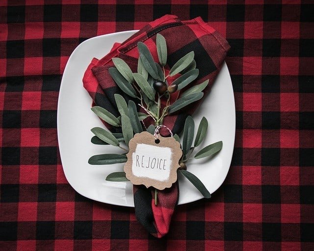 Simple Christmas Table Setting with checkered table cloth and fresh olive branch