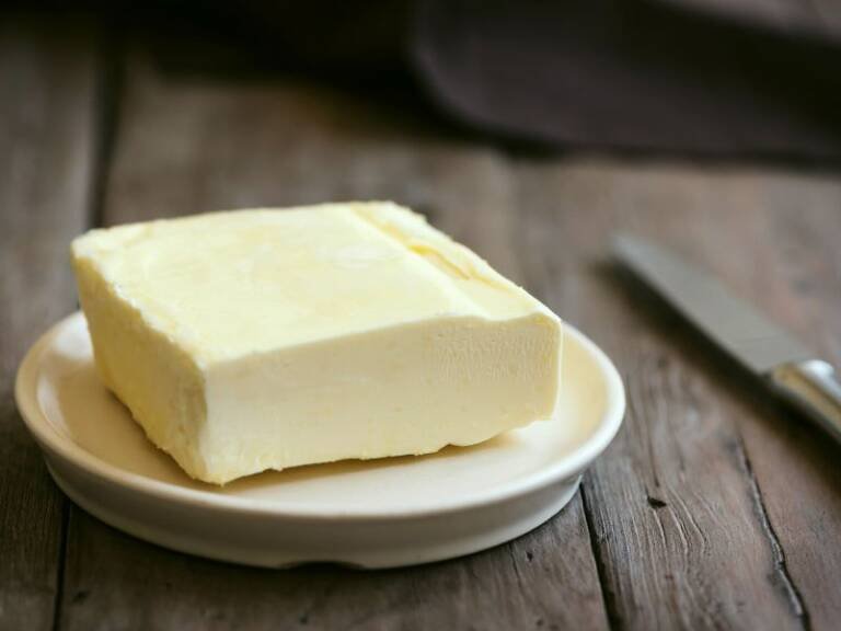 a block of homemade butter on a wooden table