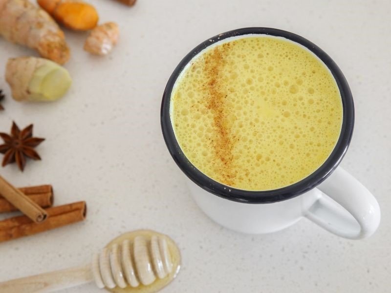 a mug full of milk with turmeric added in