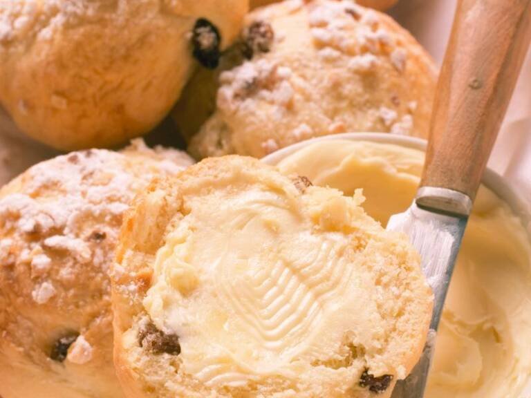 creamy maple syrup butter spread on currant muffins