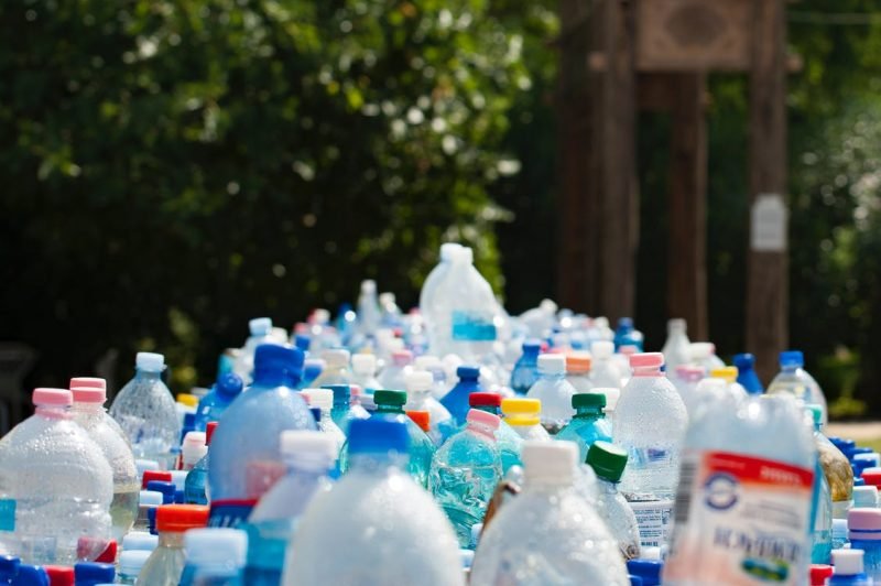 a lot of plastic bottles and jugs that are ready to be recycled at a recycling center