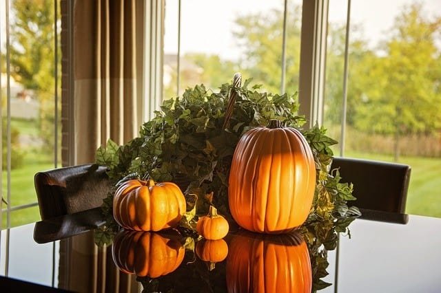 3 fresh pumpkin on glass top table for fall decor